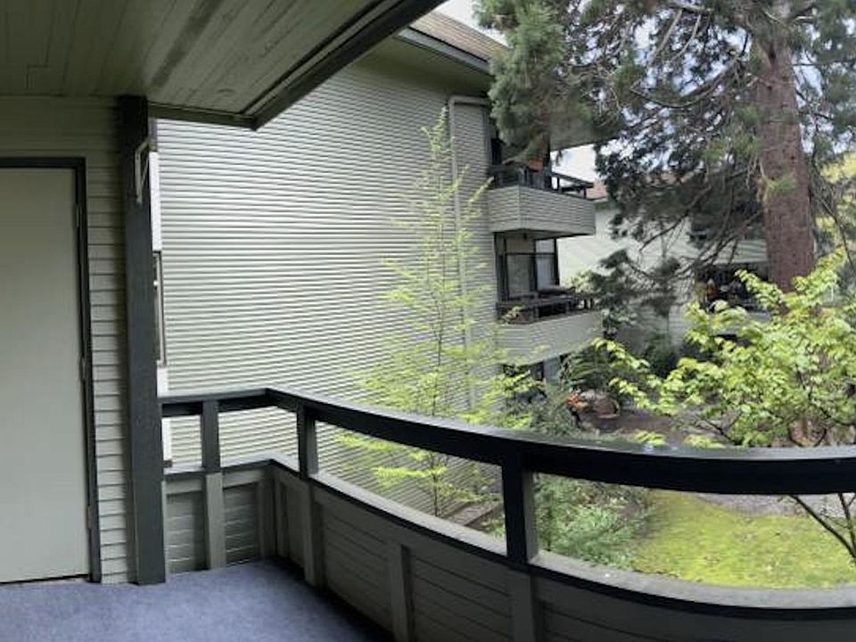 Balcony with storage room and green views of courtyard.