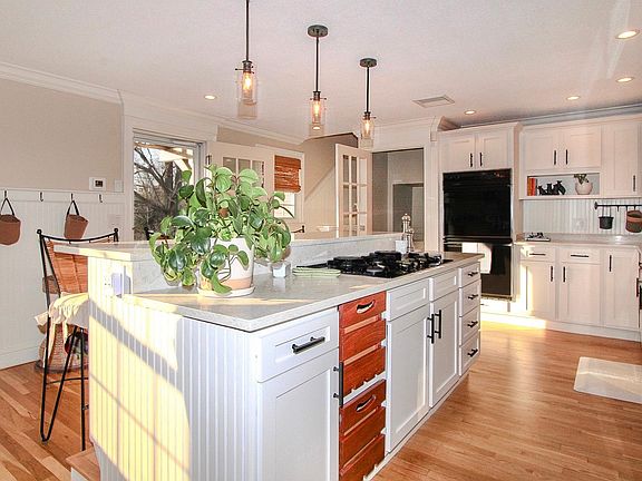 Beautiful, newly renovated, open-concept kitchen with commercial size refrigerator / freezer and 4 person breakfast bar. Kitchen is fully stocked with pots, pans, utensils, dishes, glassware, dishwasher, disposal, electric double oven, gas cook-top, coffe