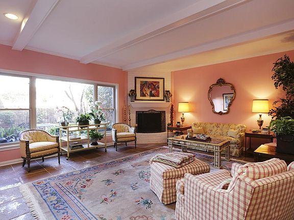 Spacious living area (20x18) with tile floors, corner fireplace, exposed beams and a beautiful view of the patio area.