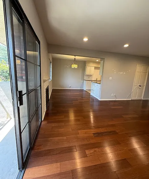 Living room facing the dining area & kitchen next to the private balcony