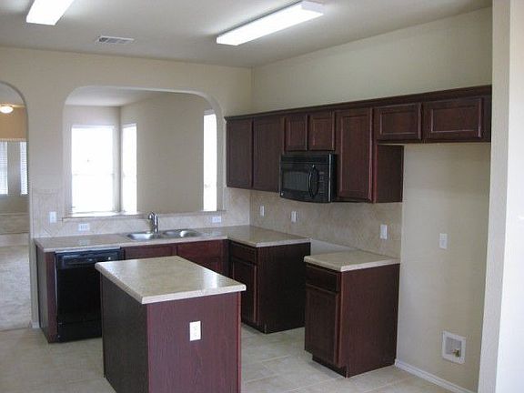 Island kitchen provides extra work space and storage