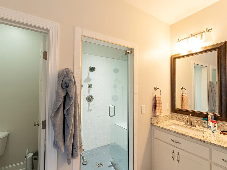 Master Bath featuring dual vanities, large walk-in shower, and water closet