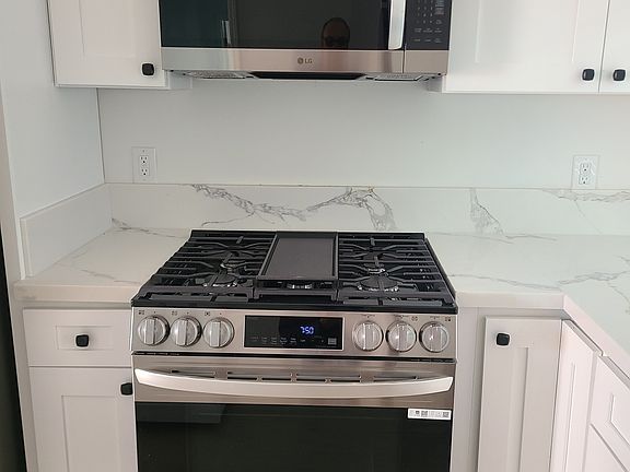 Oven/range with built-in microwave vent hood.