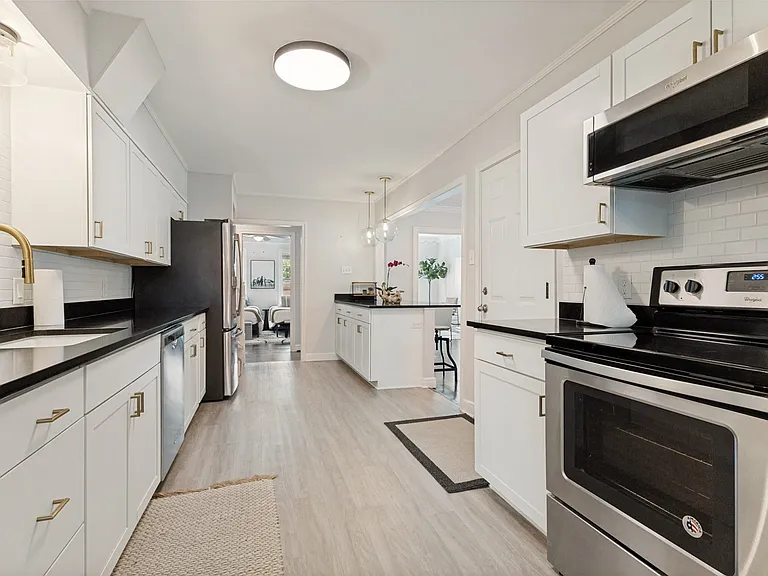Galley kitchen with stainless steel appliances. And lots of countertop space.