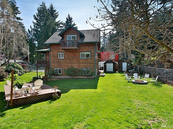 Side view of home. Three levels of living, Main floor (kitchen/dining/living, bedroom & full bath), Upper level Master Ensuite, and lower level great room with own entrance. 