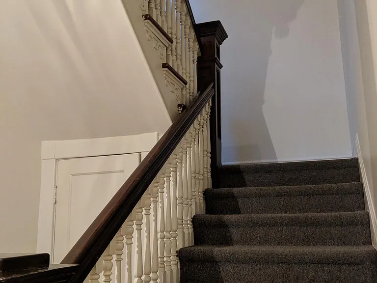Stairs from front door to living room. Front door foyer where bikes can be stored. Foyer with coat closet. Note: stairs are steep.