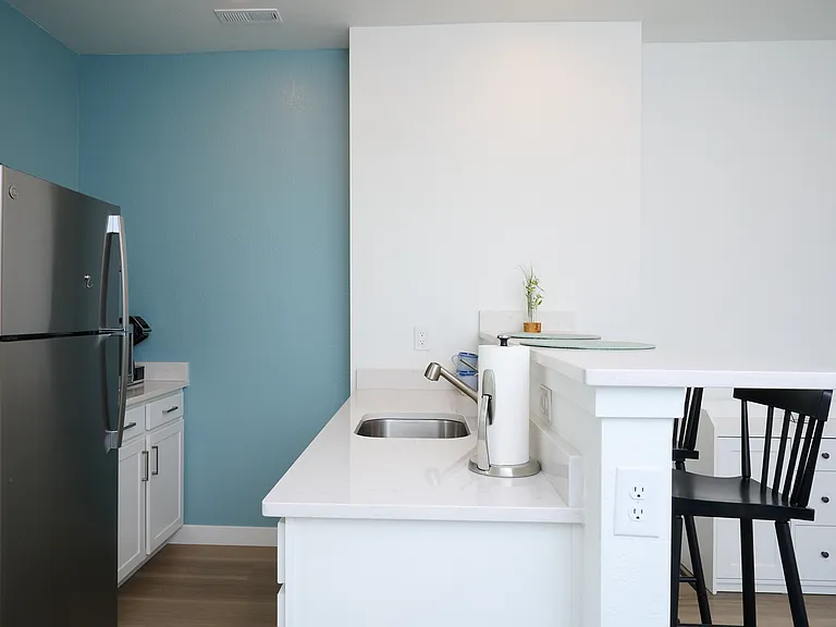 Kitchen appliances including refrigerator, countertop oven, microwave, and coffee maker.