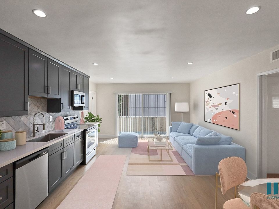 Open-Concept Kitchen with Stainless-Steel Refrigerator, Dishwasher, Stove, and Microwave Oven