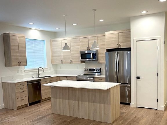 Full size kitchen with pantry closet, large island, large fridge, microwave, dishwasher, large sink w/ disposal