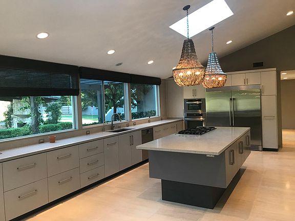 Bright kitchen over lopatio, pool and garden