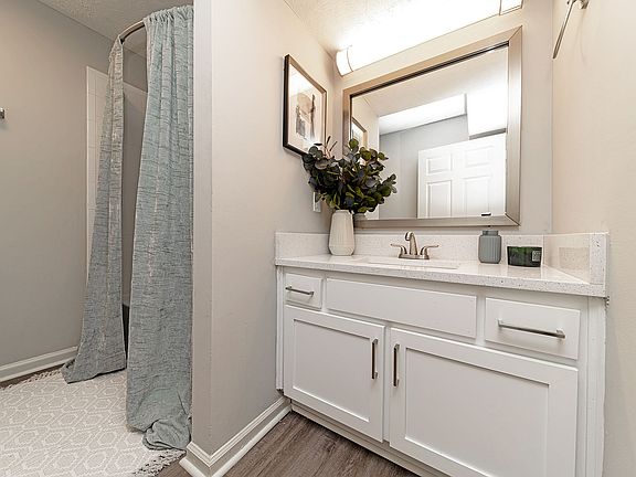 Bright bathroom with quartz counters and modern cabinetry