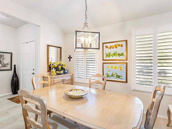 A view of the dining room back towards the entry. The updated lighting adds a stylish touch.