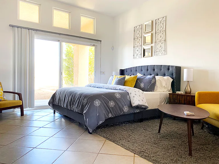Yellow Bedroom: California King size bed, tall ceiling, walk-in closet, electric fireplace, back yard access, expansive desert and mountain views