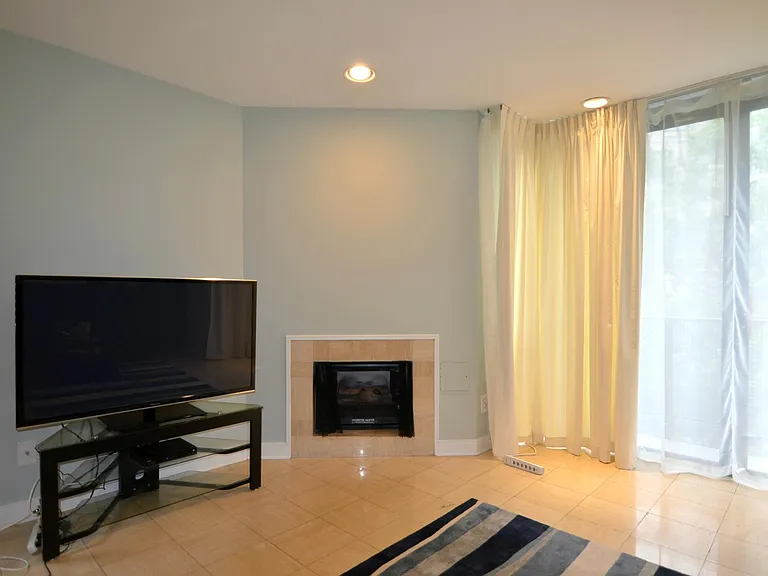 Living room featuring a cozy fireplace and modern finishes