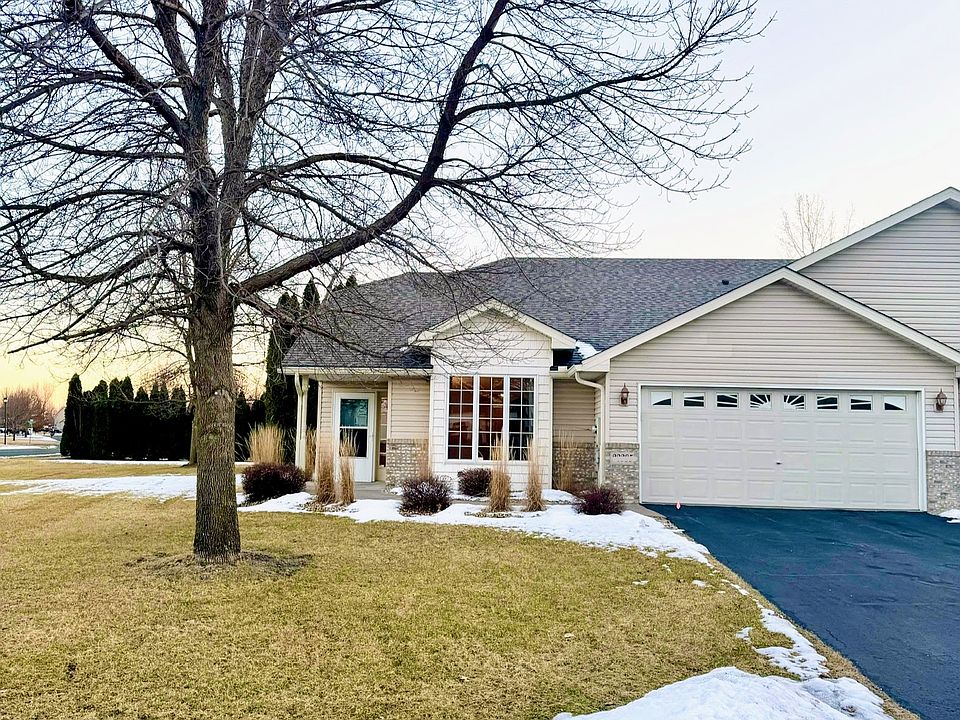 Exterior of home. 2 Car garage, newer roof, end unit on corner lot with large yard.