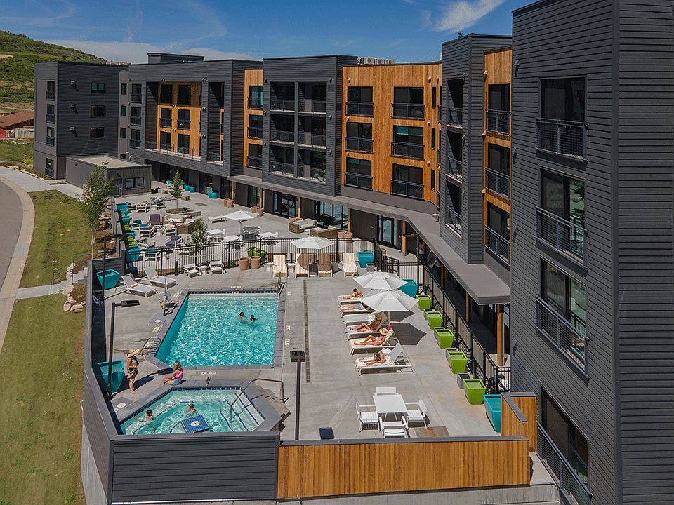 __ Aerial view of the pool, hot tub, and relaxation area
__ Take in the stunning aerial view of the pool, hot tub, and tranquil relaxation area. The perfect spot to unwind, soak up the sun, and enjoy the serene surroundings after a day of adventure.