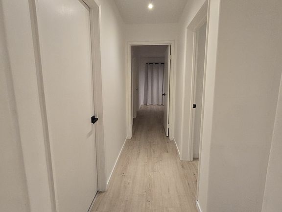 Hallway with doors to hallway bath, second bedroom (right) and master bedroom
