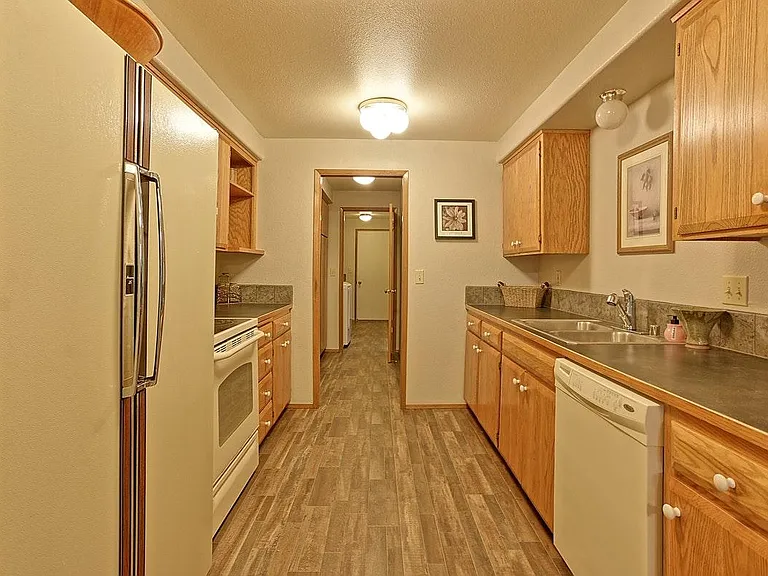 Kitchen w/ DW, Refer, stove
Picture shows white appliances, but they are stainless steel