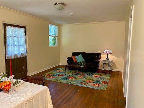 The living room/dining room combination, freshly painted , with hardwood floors.
