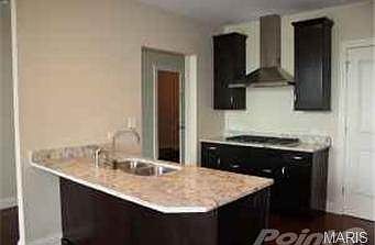 Custom kitchen with granite countertops and stainless applia