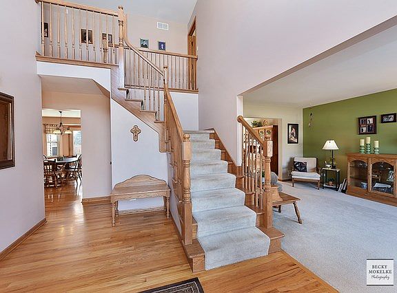 The two story foyer is gorgeous. The curved staircase just adds to the elegance of this entry.