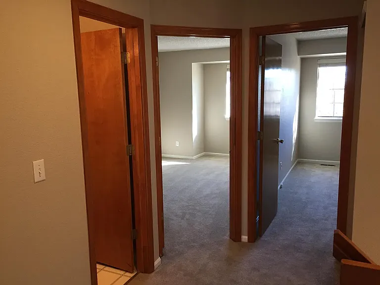 The interior is spacious and open, with brand new plush carpeting and large windows throughout.