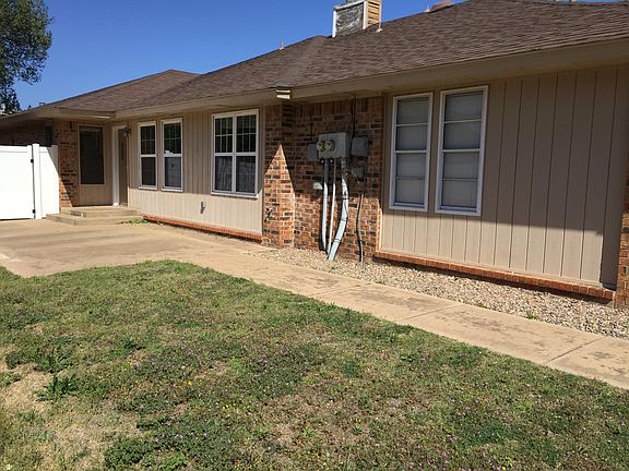 Front door / patio area from sidewalk with private backyard