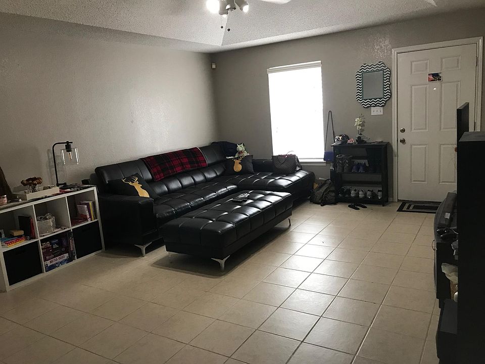 Large living room with ceiling fan and recessed ceiling.