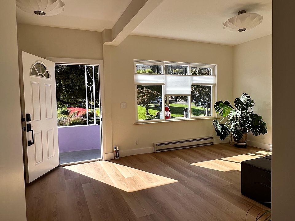 Sun drenched living room with coat closet, high ceilings and double pane windows, top/down blinds.