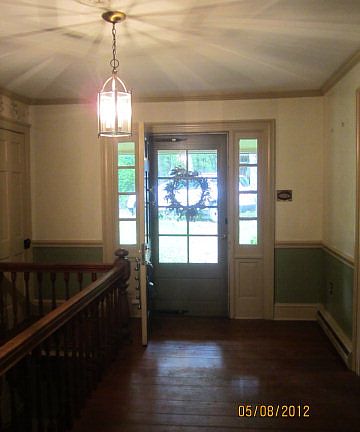 This foyer has a coat closet and the stairs to the lower level