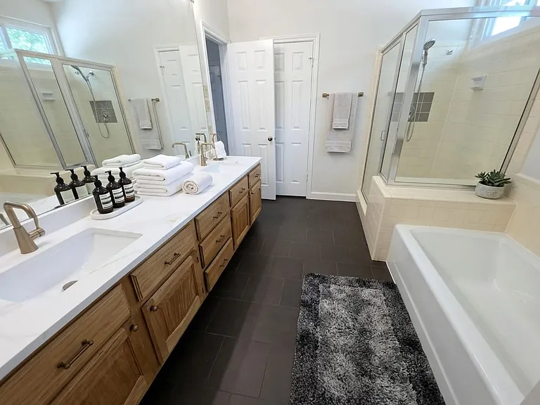 Primary bathroom featuring separate toilet area and secondary closet.
