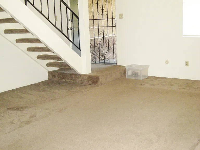 Living room has the steps to the second floor.