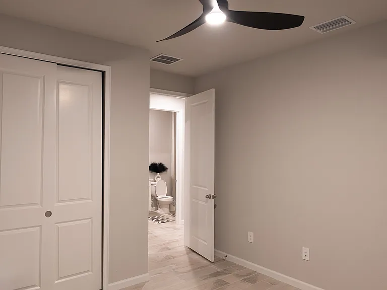 View of Second bedroom into adjacent bathroom