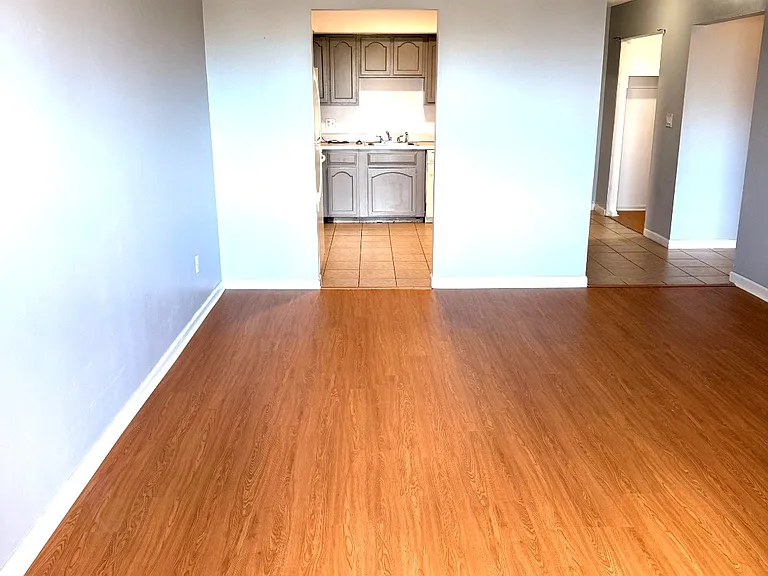 Spacious living room with natural light from the balcony doors
