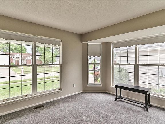 The living room boasts tons of natural light with windows galore.