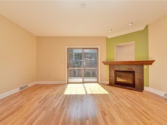Gleaming hardwood floors looking towards your deck and fireplace.