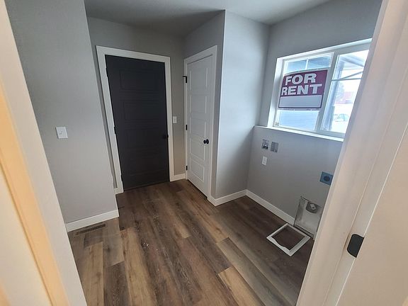 Laundry room/mudroom with coat closet and access to garage