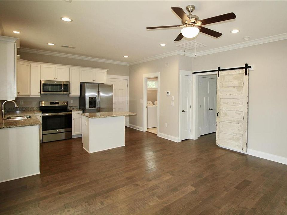 Kitchen (view from family room). Entrance door is next to the refrigerator.