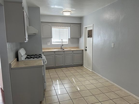 Kitchen with refinished cabinets and newly installed industrial Kohler sink.