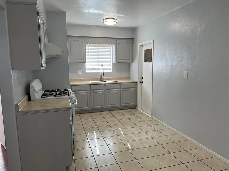 Kitchen with refinished cabinets and newly installed industrial Kohler sink.