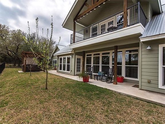 The back of the home boasts a covered back porch as well as a covered upstairs balcony which is off the second master. Sidewalk leads to hot tub and casita.