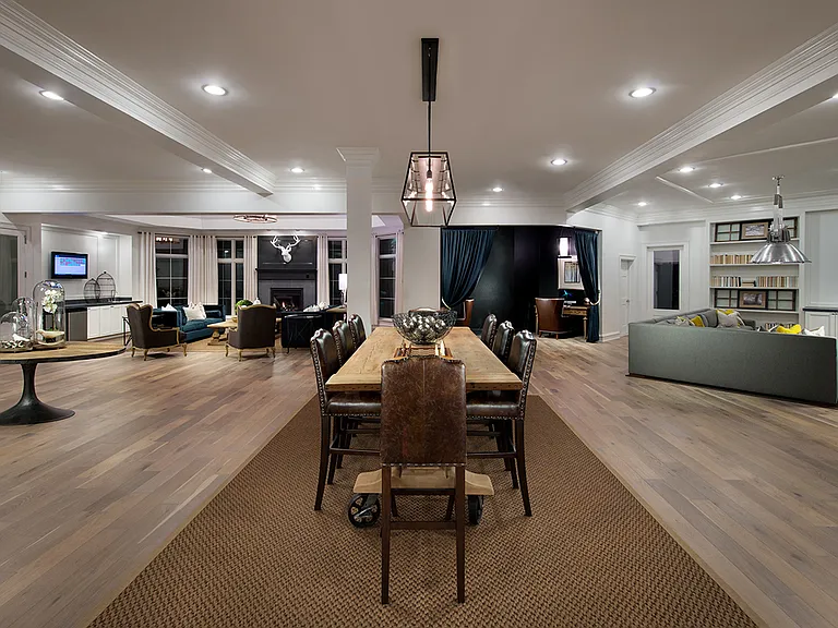 Club House with large dining table, fireplace, television and golf simulator