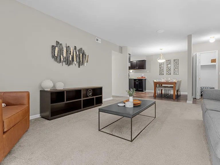 Open concept Living-Dining Area with natural lighting at Lakeside Village Apartments Clinton Township, MI