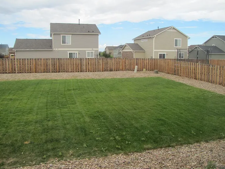 Large fenced yard with Auto Sprinkler system with both backyard and front