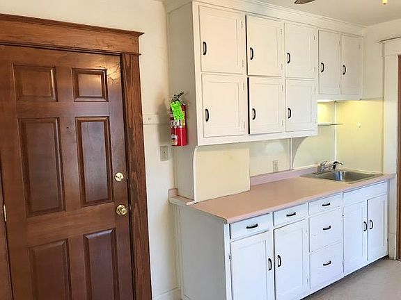 Front door as you walk into the kitchen. Fire extinguisher provided in every unit.