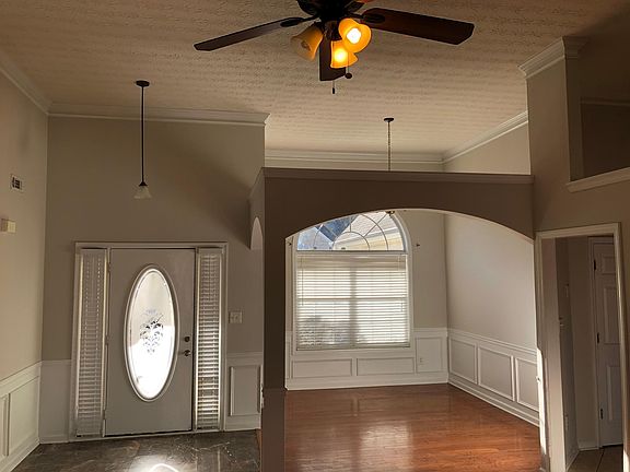 Front Entry - Marble & Hardwoods; Dining Room with Arched Opening