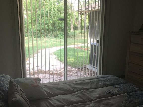 Master bedroom with view of backyard