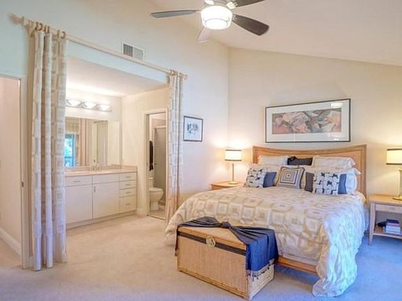 master BR with a vaulted ceiling with a garden view and balcony