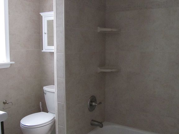 Tile Bathroom has washer/dryer