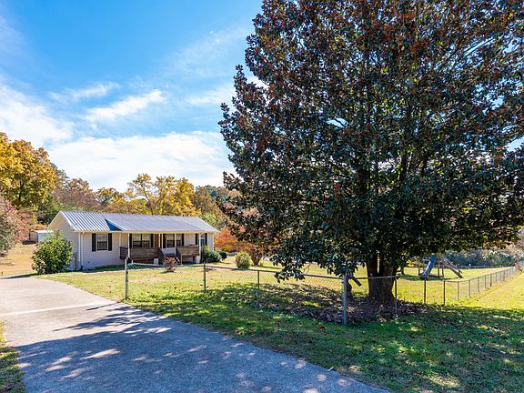 View of fence that surrounds entire yard and rolls across driveway